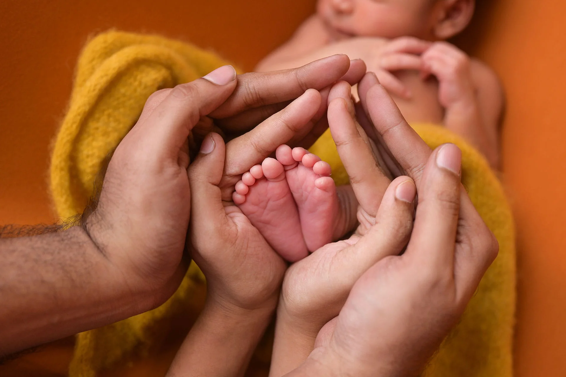 newborn detail shot with parents