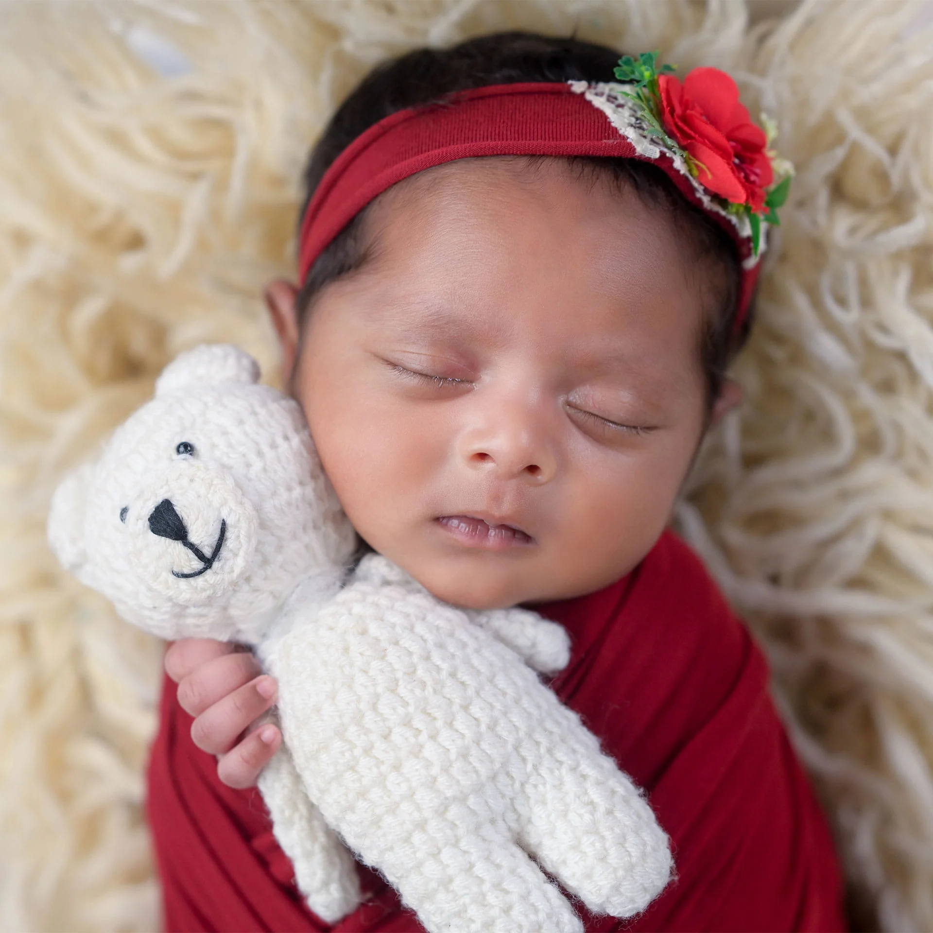 newborn holding teddy bear
