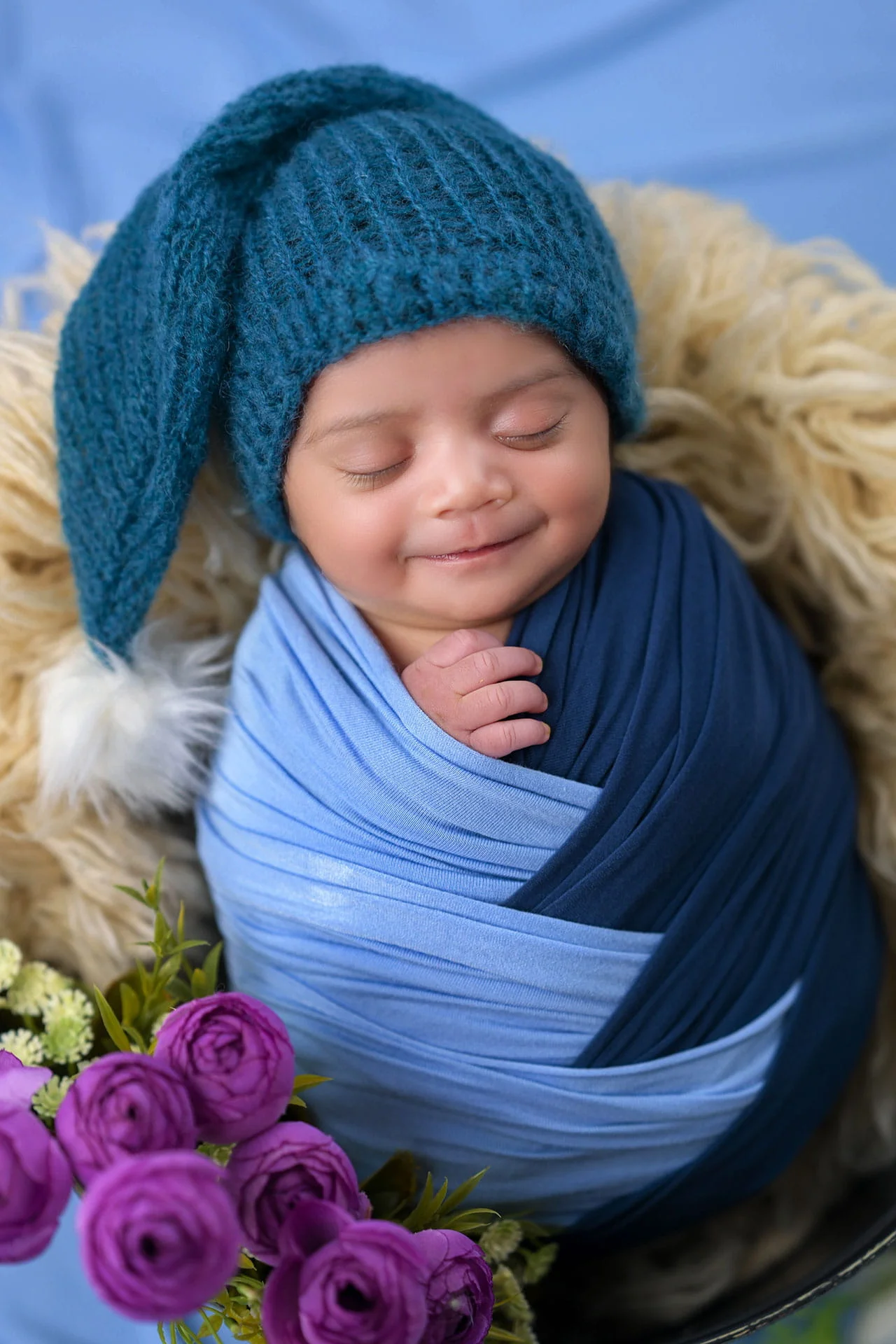 newborn baby in blue wrap