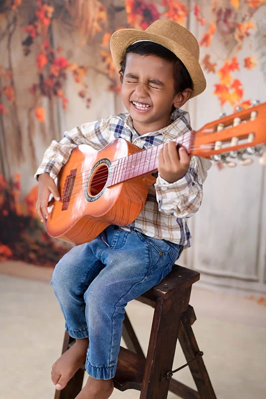 4 year old playing guitar